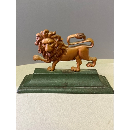 325 - A regency style cast iron door stop in the shape of a lion.