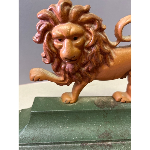 325 - A regency style cast iron door stop in the shape of a lion.