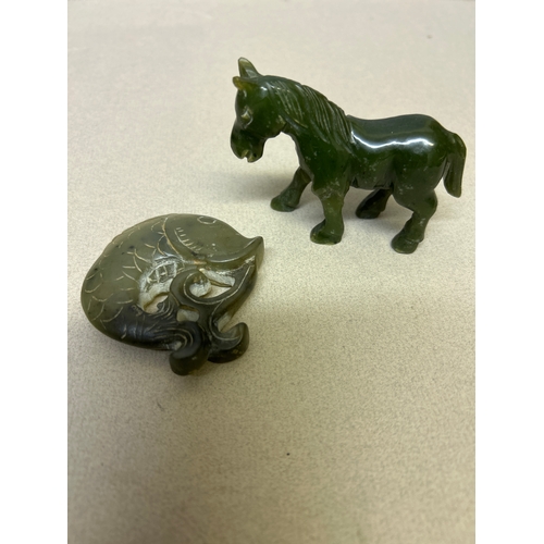102 - Two pieces of carved jade including a horse snd a carp fish