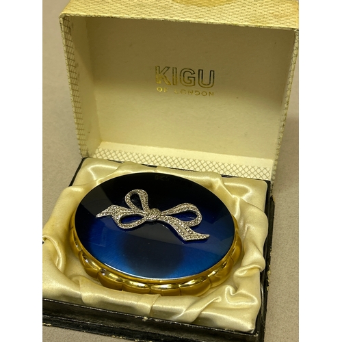 143 - A vintage Kigu “Concerto” musical compact, the cobalt blue lid with marcasite bow. Original box.
