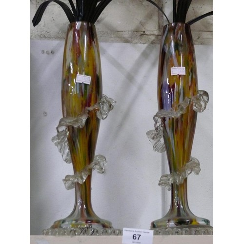 67 - Pair of multi coloured glass vases with a spiral frill design  and faux White flowers