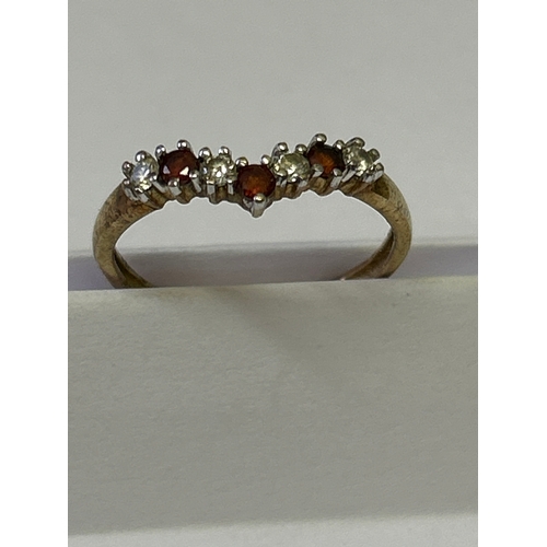 119 - A 9ct gold wishbone ring set with cubic zirconia and garnets. Size M , 1.3 grams
