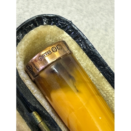 123 - An amber cheroot holder with a 9ct gold tip hallmarked London 1922 with original leather case.