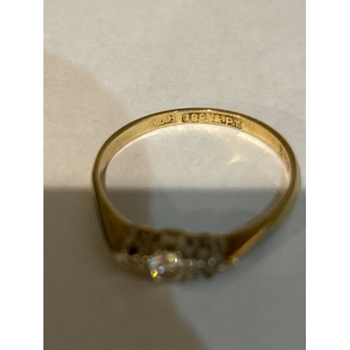 47C - An antique 18ct gold trilogy ring with .15 ct brilliant cut diamond set in platinum, flanked by a sm... 