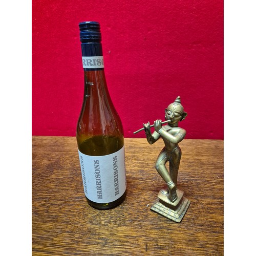 290 - Brass figurine of the Hindu deity Krishna playing the flute. 19cm tall.