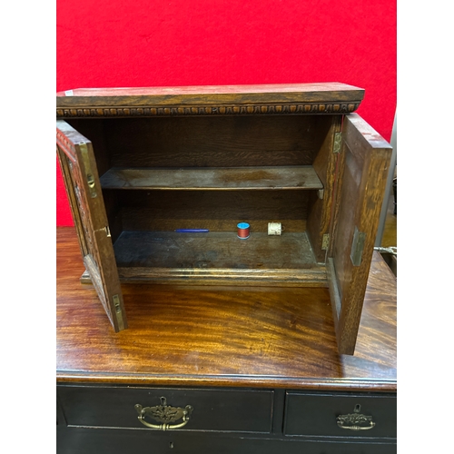 597 - A late 19th small oak cupboard with carved door panels representing the tree of life. Internal shelf... 