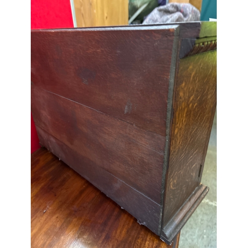 597 - A late 19th small oak cupboard with carved door panels representing the tree of life. Internal shelf... 