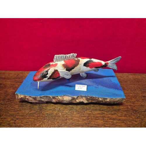 338 - Hand carved and painted Koi Carp model on heavy wooden base.
