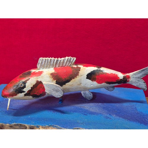338 - Hand carved and painted Koi Carp model on heavy wooden base.