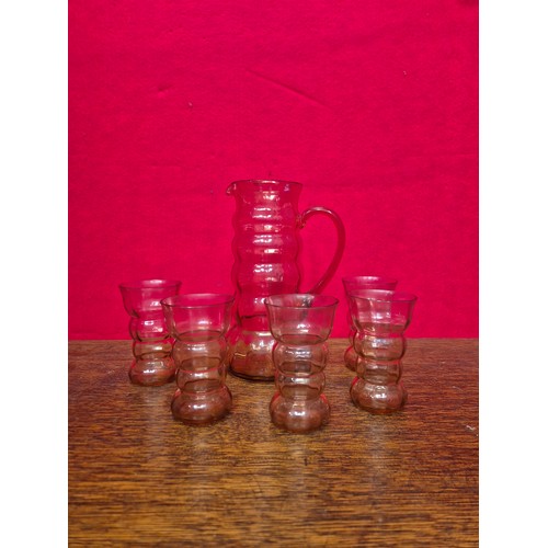 350 - Rose pink depression glass lemonade set, with 5x banded glasses and matching pitcher with ground pon... 