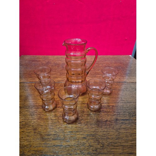 350 - Rose pink depression glass lemonade set, with 5x banded glasses and matching pitcher with ground pon... 