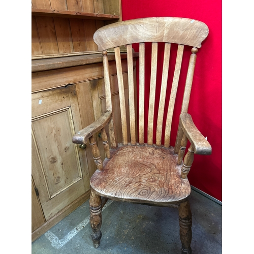 670 - A Victorian grandfather chair with elm seat and lathe back - wide seat making it a comfortable chair... 