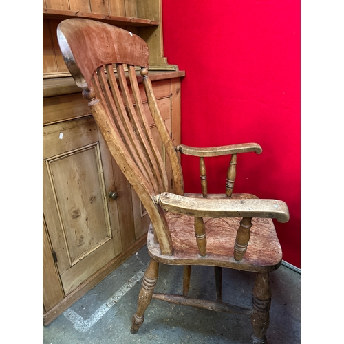670 - A Victorian grandfather chair with elm seat and lathe back - wide seat making it a comfortable chair... 