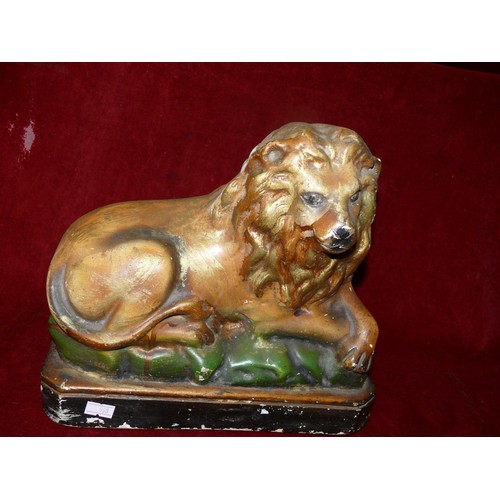397 - Early 20thC carnival chalkware statue of a recumbent lion. Approx 24cm tall.