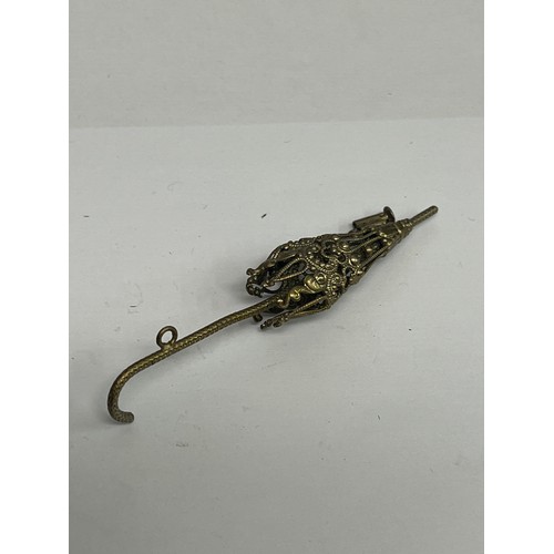 67M - A bronze belt buckle, early 20th century, a brooch of flowers and a lovely parasol in filigree work.