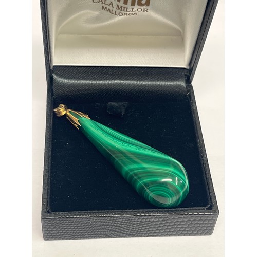 67D - A natural malachite tear drop pendant with 14ct gold fittings.