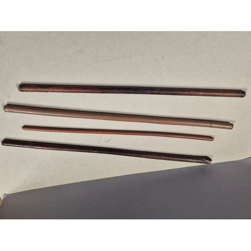 550 - Four vintage/antique Army officers swagger sticks, made of bamboo cane with stitched leather covers.