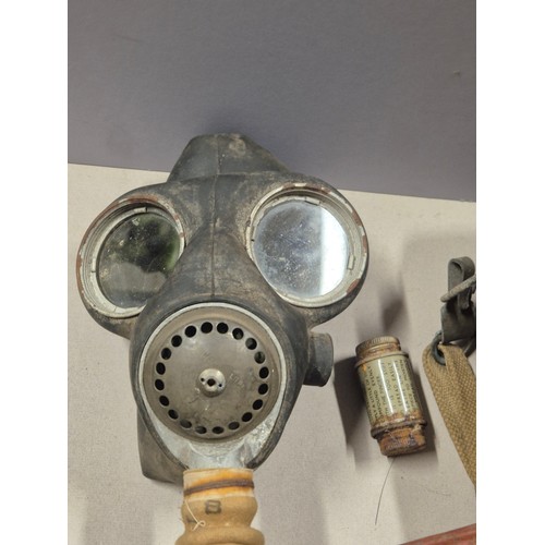 552 - WWII British issue gas mask. Model No.4 Mk.III gas mask, dated 1941 on headstrap. Complete with hose... 
