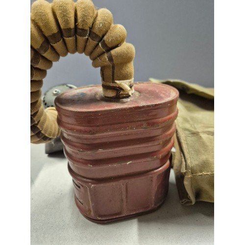 552 - WWII British issue gas mask. Model No.4 Mk.III gas mask, dated 1941 on headstrap. Complete with hose... 