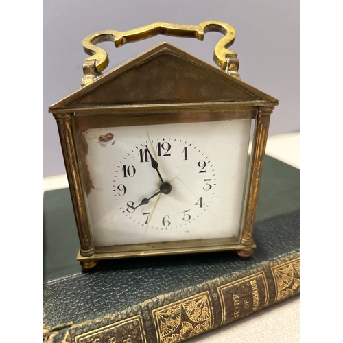 137 - A 19th Century French brass carriage clock with unusual triangular arched top complete with key and ... 