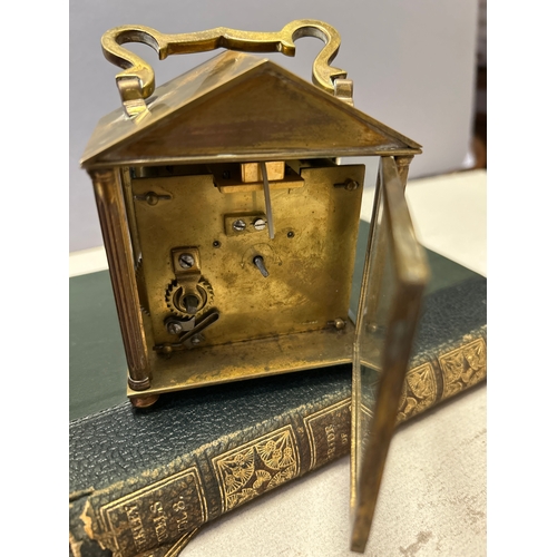 137 - A 19th Century French brass carriage clock with unusual triangular arched top complete with key and ... 