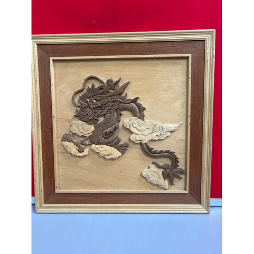 222 - Two Far Eastern carved wood pictures, one of cranes and the other a Chinese dragon. 60cm x 60cm