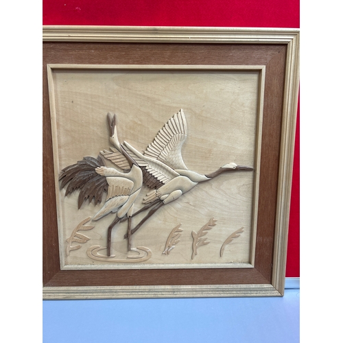 222 - Two Far Eastern carved wood pictures, one of cranes and the other a Chinese dragon. 60cm x 60cm