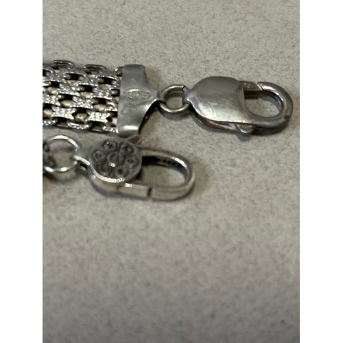 95A - Two sterling silver bracelets, one a fine sterling silver gate bracelet with decorative multi links ... 
