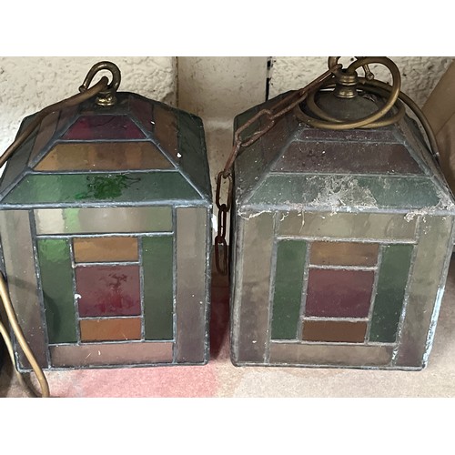 452 - Three early 20thC leaded glass pendant lamp shades, wired to electric with brass fittings and staine... 