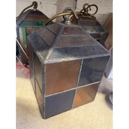 452 - Three early 20thC leaded glass pendant lamp shades, wired to electric with brass fittings and staine... 