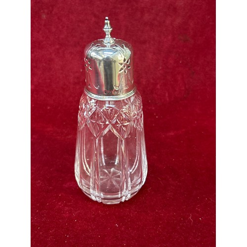 107 - George V cut glass sugar sifter with pierced silver top. Hallmarked for Walker-Hall Birmingham 1928.... 