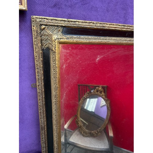 234 - A very large & decorative wall mirror with bevelled glass, the frame with gilt gesso detail against ... 