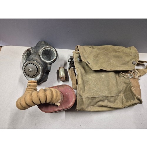 552 - WWII British issue gas mask. Model No.4 Mk.III gas mask, dated 1941 on headstrap. Complete with hose... 