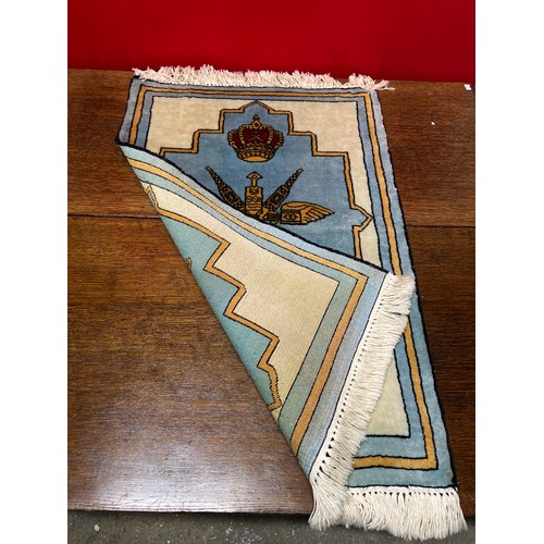 219A - An Omani prayer rug with fringed ends, decorated with the national emblem of the Sultinate of Oman i... 