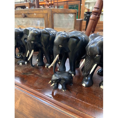 245 - A family of 9x carved ebony elephant sculptures.