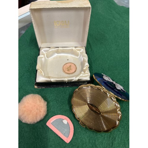 143 - A vintage Kigu “Concerto” musical compact, the cobalt blue lid with marcasite bow. Original box.