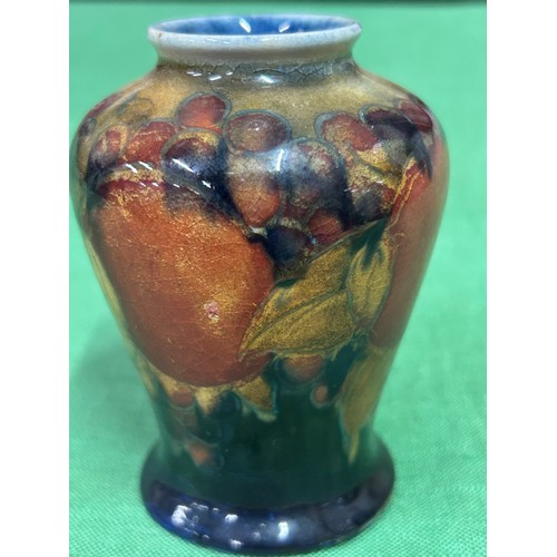 10 - An early 20th Century Moorcroft vase in the Pomegranate pattern with impressed marks “MOORCROFT ENGL... 