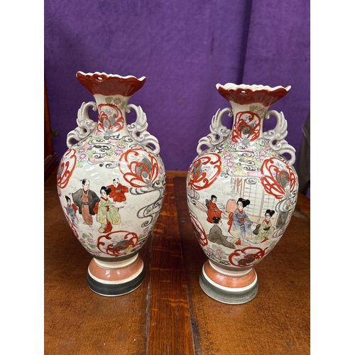 151 - Pair of early 20th Century Japanese Satsuma vases handpainted with figures in a garden. Restoration ... 