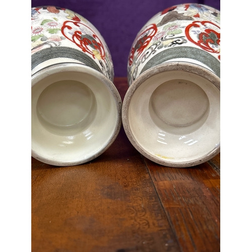 151 - Pair of early 20th Century Japanese Satsuma vases handpainted with figures in a garden. Restoration ... 
