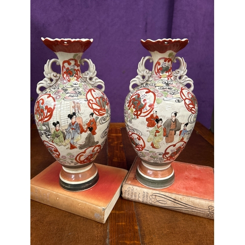 151 - Pair of early 20th Century Japanese Satsuma vases handpainted with figures in a garden. Restoration ... 