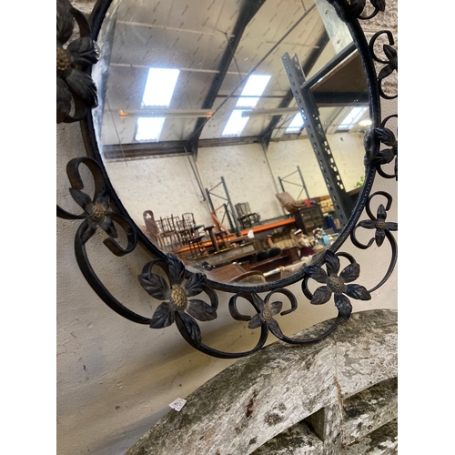 155 - Vintage round wall mirror, with decorative black wrought iron floral frame. 35cm diameter mirror, 46... 