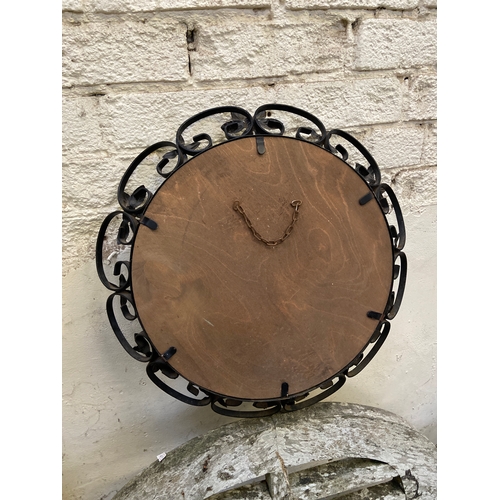 155 - Vintage round wall mirror, with decorative black wrought iron floral frame. 35cm diameter mirror, 46... 