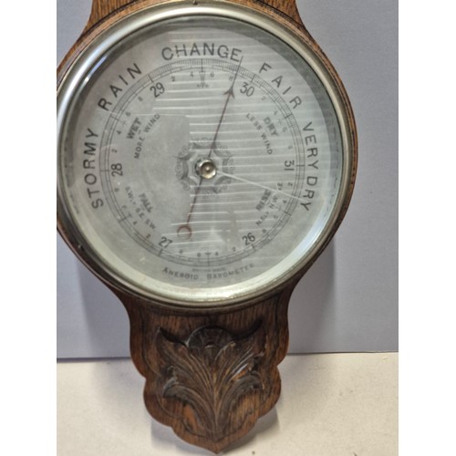 156 - Edwardian aneroid barometer and thermometer in carved oak case, together with another barometer in A... 