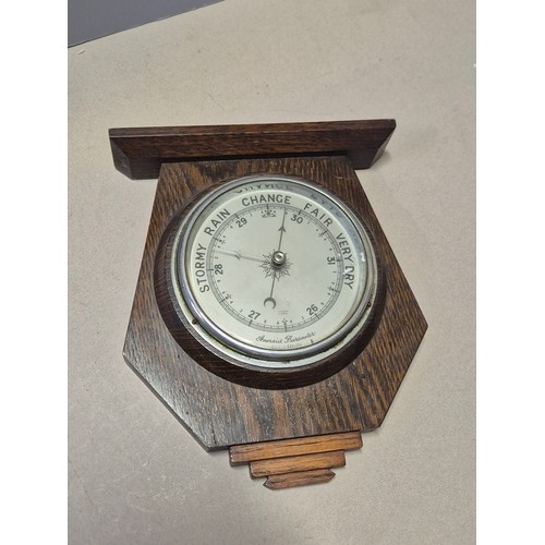156 - Edwardian aneroid barometer and thermometer in carved oak case, together with another barometer in A... 