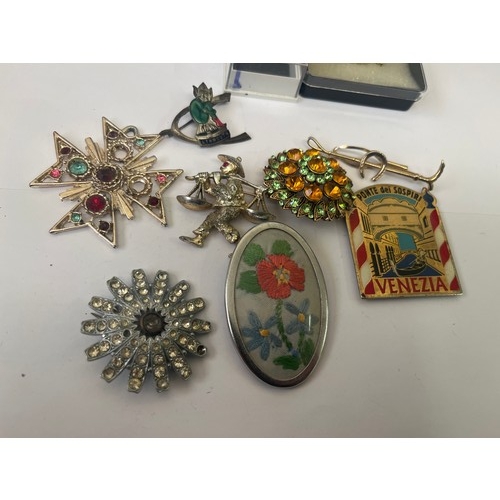 16 - a tub of brooches,  badges and earrings