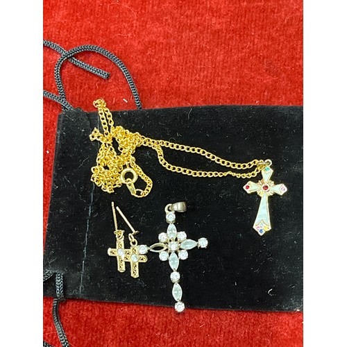 29 - A pair of 9ct gold cross earrings with white stones and also two cross pendants, one inlaid with mot... 