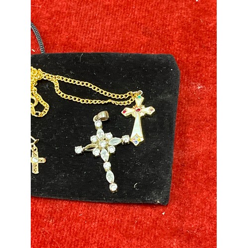 29 - A pair of 9ct gold cross earrings with white stones and also two cross pendants, one inlaid with mot... 