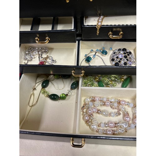 33 - Good quality black leather effect jewellery box with contents of costume jewellery - necklaces, brac... 