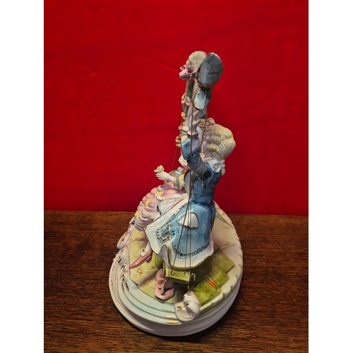 20 - A very large Capodimonte porcelain figurine of a courting couple on a swing. Polychrome and gilt dec... 
