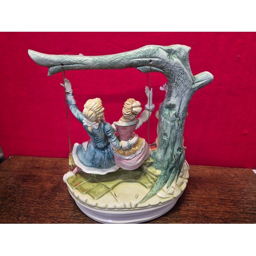 20 - A very large Capodimonte porcelain figurine of a courting couple on a swing. Polychrome and gilt dec... 